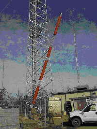 The antenna being hoisted up the tower